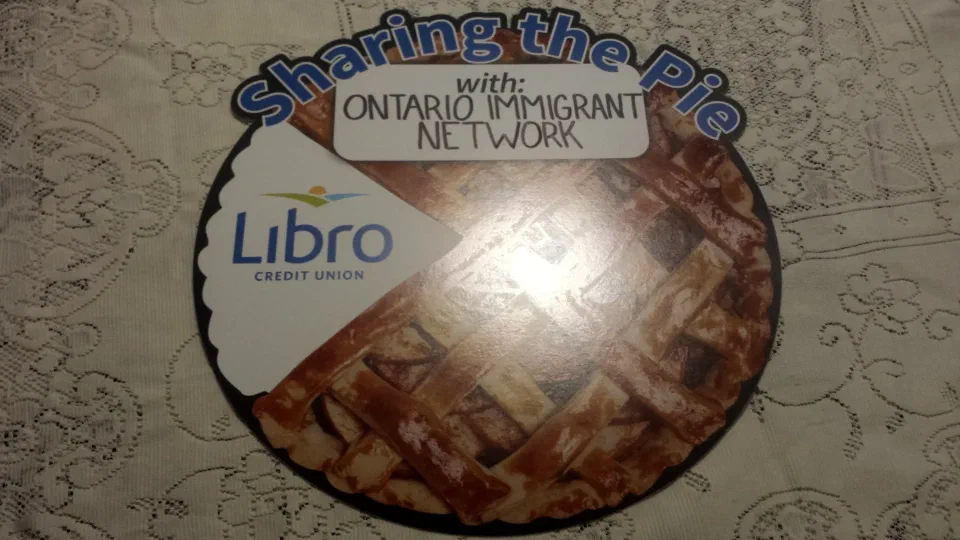 Libro Credit Union's Sharing the Pie cut-out, with Ontario Immigrant Network's name on its slice